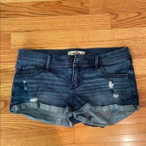 Blue lightly distressed low rise jean shorts